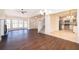 Open concept living area with a view into the kitchen and stairwell at 120 W Minnehaha Ave, Clermont, FL 34711