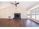 Spacious living room features wood floors, fireplace, and a large bay window at 120 W Minnehaha Ave, Clermont, FL 34711