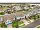 An aerial view displays a neighborhood's neatly lined homes, showcasing various architectural designs and well-maintained landscaping at 14160 Dove Hollow Dr, Orlando, FL 32824