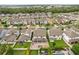 An aerial view shows a neighborhood with backyard pools, brick patios, and lush landscaping at 14160 Dove Hollow Dr, Orlando, FL 32824
