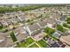 An aerial view showcases residences, landscaping, pools, brick patios, and artificial turf at 14160 Dove Hollow Dr, Orlando, FL 32824