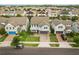 An aerial view displays a well-maintained residential neighborhood with lush greenery and varied rooflines at 14160 Dove Hollow Dr, Orlando, FL 32824