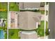 Aerial view of a home with a brick patio, fire pit, and manicured lawn at 14160 Dove Hollow Dr, Orlando, FL 32824
