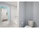 A bright bathroom features a bathtub, white tiled walls, and a stylish toilet at 14160 Dove Hollow Dr, Orlando, FL 32824
