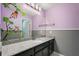 A vibrant bathroom featuring playful decor, a granite countertop, and a sleek, modern vanity at 14160 Dove Hollow Dr, Orlando, FL 32824