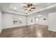 Spacious bedroom with tray ceiling, wood floors, and abundant natural light at 14160 Dove Hollow Dr, Orlando, FL 32824