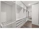 A modern closet with white shelving, drawers, and a mirror, providing ample storage and organization at 14160 Dove Hollow Dr, Orlando, FL 32824