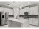 Modern kitchen boasts stainless steel appliances, white cabinets, and a spacious center island at 14160 Dove Hollow Dr, Orlando, FL 32824