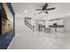Bright, open living area with tile floors, modern staircase, and kitchen with stainless steel appliances at 14160 Dove Hollow Dr, Orlando, FL 32824