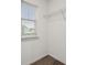 A walk-in closet offers natural light, wood-look floors and wire shelving for optimized storage at 14160 Dove Hollow Dr, Orlando, FL 32824
