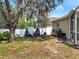 Private backyard with a fire pit, mature trees, and a cozy seating area at 149 Imperial Oak Ct, Davenport, FL 33896