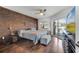 Comfortable bedroom with a rustic wood accent wall and a view of the pool area at 149 Imperial Oak Ct, Davenport, FL 33896