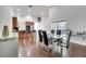 Open-concept dining area with dark floors and a view of the kitchen and sliding glass doors at 149 Imperial Oak Ct, Davenport, FL 33896