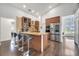 Open-concept kitchen with granite counters, stainless appliances, and raised bar with seating at 149 Imperial Oak Ct, Davenport, FL 33896