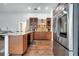 Open kitchen featuring stainless appliances, granite countertops, mosaic backsplash, and wood cabinets at 149 Imperial Oak Ct, Davenport, FL 33896