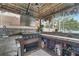 Outdoor kitchen/tiki bar with built-in grill, sink, tiled backsplash, and ample storage at 149 Imperial Oak Ct, Davenport, FL 33896