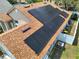 Close-up of modern solar panels installed on a home's roof, highlighting the clean energy feature at 149 Imperial Oak Ct, Davenport, FL 33896
