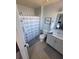 Neat bathroom featuring a shower, commode, vanity and neutral decor at 153 Pompano Beach Dr Dr, Kissimmee, FL 34746