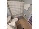 Cozy bathroom with tile flooring, modern toilet, and shower with striped curtain at 153 Pompano Beach Dr Dr, Kissimmee, FL 34746