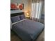 Cozy bedroom with a queen-size bed, side table, and decorative artwork at 153 Pompano Beach Dr Dr, Kissimmee, FL 34746