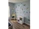 Charming bedroom with marine wall art, stylish storage, and modern flooring at 153 Pompano Beach Dr Dr, Kissimmee, FL 34746
