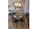 Dining area boasting a glass table with seating for four set under a chandelier at 153 Pompano Beach Dr Dr, Kissimmee, FL 34746