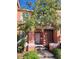 Charming two-story townhouse featuring a walkway, decorative shutters, and lush landscaping at 153 Pompano Beach Dr Dr, Kissimmee, FL 34746