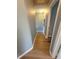 Inviting hallway features durable wood-look flooring and neutral wall paint at 153 Pompano Beach Dr Dr, Kissimmee, FL 34746