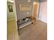 Hallway showcasing a decorated glass top table with neutral paint and tile floors at 153 Pompano Beach Dr Dr, Kissimmee, FL 34746