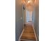 Well-lit hallway featuring modern wood flooring and neutral paint at 153 Pompano Beach Dr Dr, Kissimmee, FL 34746