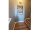 Hallway featuring a decorative bicycle print and modern wood flooring with white trim at 153 Pompano Beach Dr Dr, Kissimmee, FL 34746