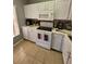 This well-lit kitchen features stainless appliances, tile backsplash and white marbled countertops at 153 Pompano Beach Dr Dr, Kissimmee, FL 34746