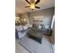 Living room area with tile flooring, great lighting, and a gray L-shaped couch at 153 Pompano Beach Dr Dr, Kissimmee, FL 34746