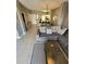 Open-concept living space featuring a comfortable gray sofa and dining area in the background at 153 Pompano Beach Dr Dr, Kissimmee, FL 34746