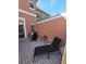 Cozy patio featuring two lounge chairs, a small table, and a charming brick paver surface at 153 Pompano Beach Dr Dr, Kissimmee, FL 34746