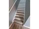 Stairway featuring light wood treads and white risers, complemented by a light gray wall at 153 Pompano Beach Dr Dr, Kissimmee, FL 34746