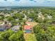 Aerial of a Gathering house in a serene neighborhood with mature trees and nearby lake at 1654 Marina Lake Dr, Kissimmee, FL 34744