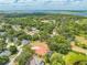Panoramic aerial view of a luxury estate home, lush landscaping, and serene lake views at 1654 Marina Lake Dr, Kissimmee, FL 34744