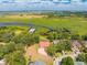 Overhead view features a home with pool and dock on a lake with a boat house at 1654 Marina Lake Dr, Kissimmee, FL 34744