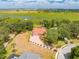 Scenic aerial shot features a red-roofed home with waterfront access, private dock, and lush landscaping amidst tranquil surroundings at 1654 Marina Lake Dr, Kissimmee, FL 34744