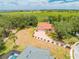 Expansive aerial view showcases the property's red-tile roof, brick driveway, lush surroundings, and access to a serene lake at 1654 Marina Lake Dr, Kissimmee, FL 34744