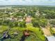 Panoramic aerial view showcasing a pool home, lush landscaping, dock with boathouse, and tranquil lake setting at 1654 Marina Lake Dr, Kissimmee, FL 34744