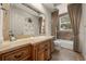 Bathroom featuring custom vanity with decorative mirror and neutral tile accents in the tub and shower at 1654 Marina Lake Dr, Kissimmee, FL 34744