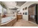 Elegant bathroom featuring a soaking tub, large mirror, and decorative accents at 1654 Marina Lake Dr, Kissimmee, FL 34744