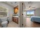 Bathroom view with a vanity and tile accents, leading to a bedroom with balcony access at 1654 Marina Lake Dr, Kissimmee, FL 34744