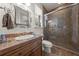 Bathroom featuring tiled shower with glass door, vanity with sink and toilet at 1654 Marina Lake Dr, Kissimmee, FL 34744