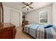 Comfortable bedroom features a light-colored wood floor, white walls, and ceiling fan at 1654 Marina Lake Dr, Kissimmee, FL 34744