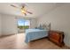 Bedroom features wood floors, a ceiling fan, and balcony access with scenic views at 1654 Marina Lake Dr, Kissimmee, FL 34744