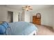 Bright bedroom features hardwood floors, a ceiling fan, dresser and closet access at 1654 Marina Lake Dr, Kissimmee, FL 34744