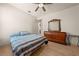 Bright bedroom with a ceiling fan, wooden floors, and a stylish dresser that enhances the room's charm at 1654 Marina Lake Dr, Kissimmee, FL 34744